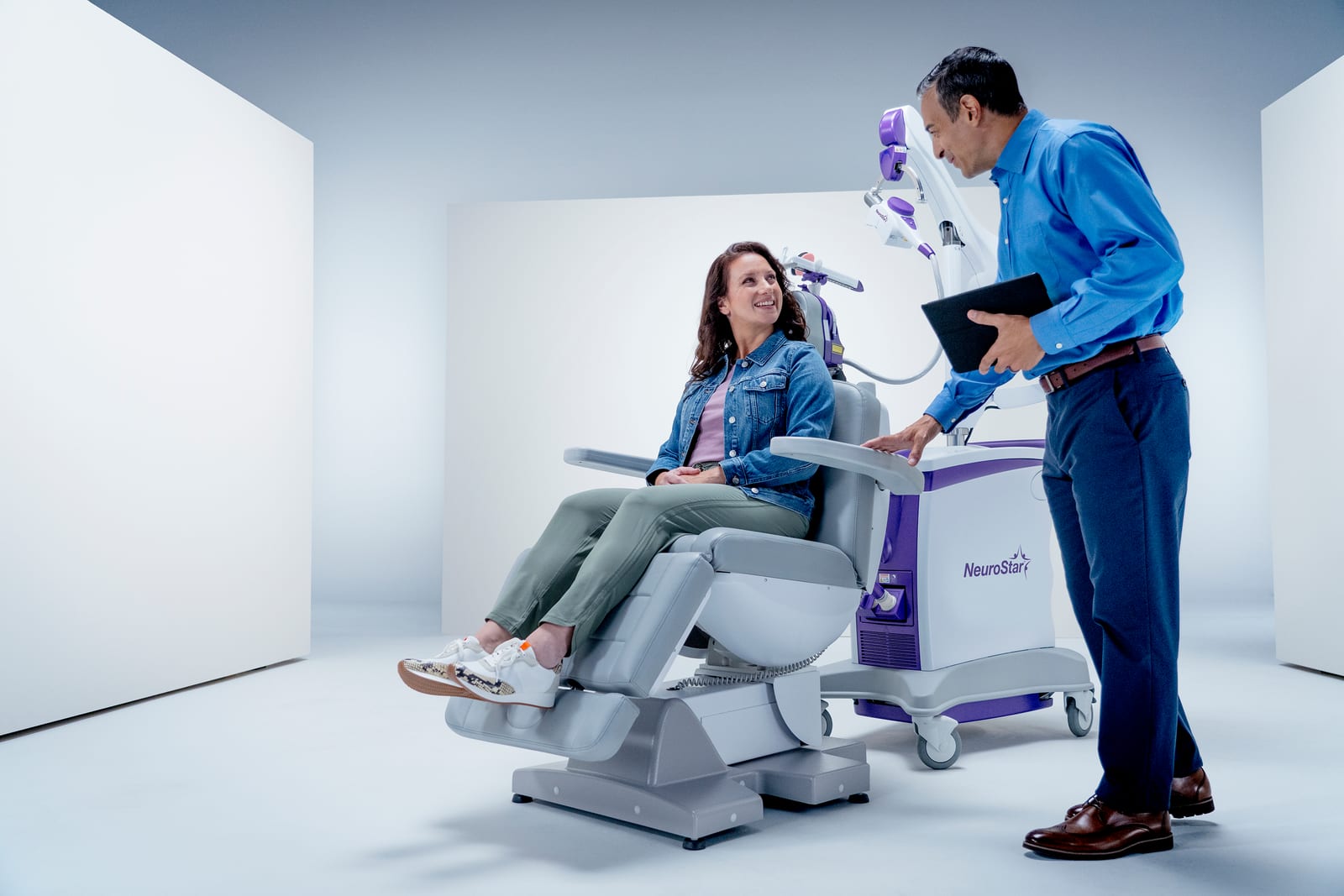 Patient in NeuroStar TMS chair during a consultation with a provider at Redi-Med Psychiatry